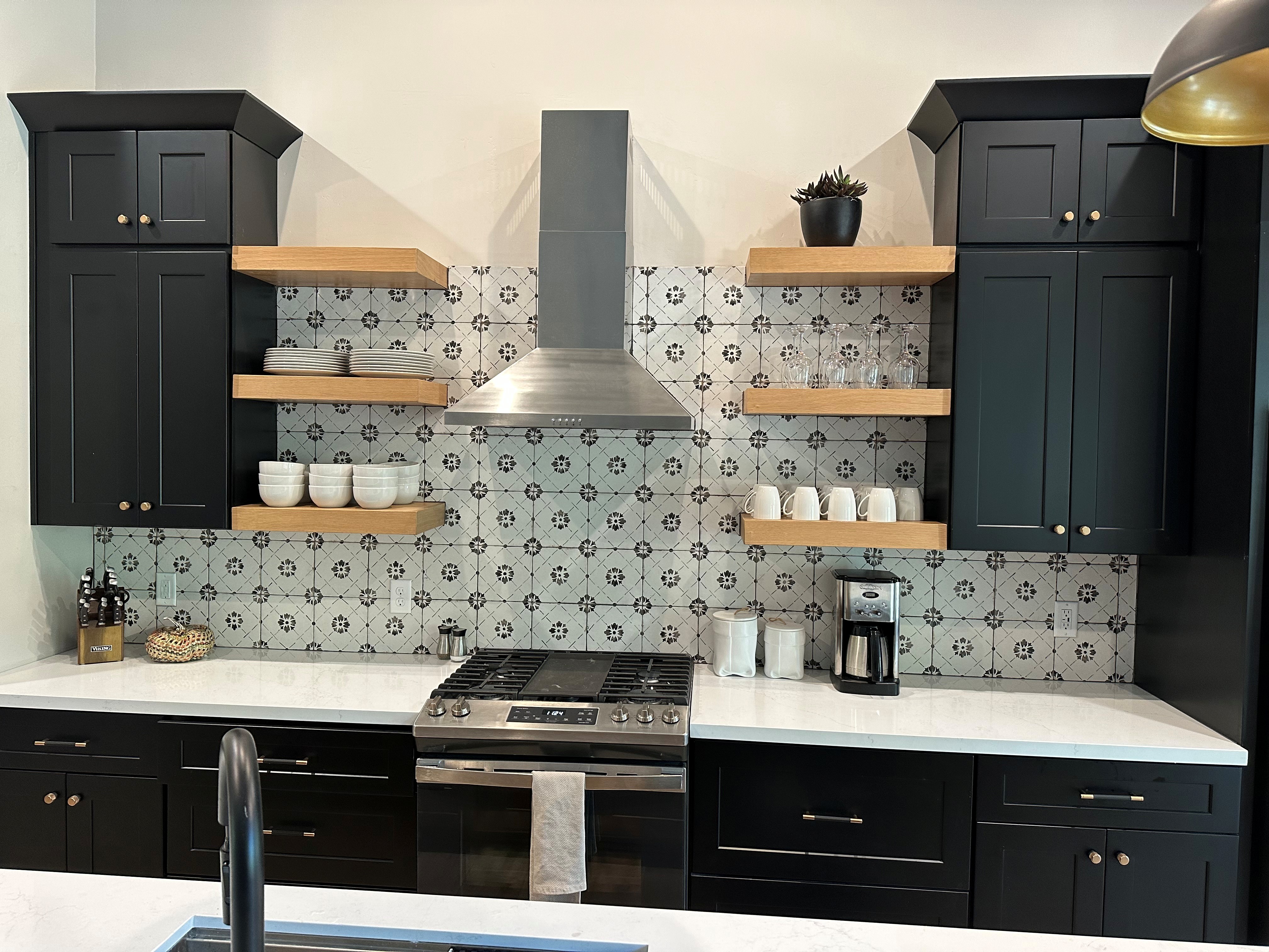 Complete kitchen renovation with custom cabinetry, tile, lighting, and open shelving